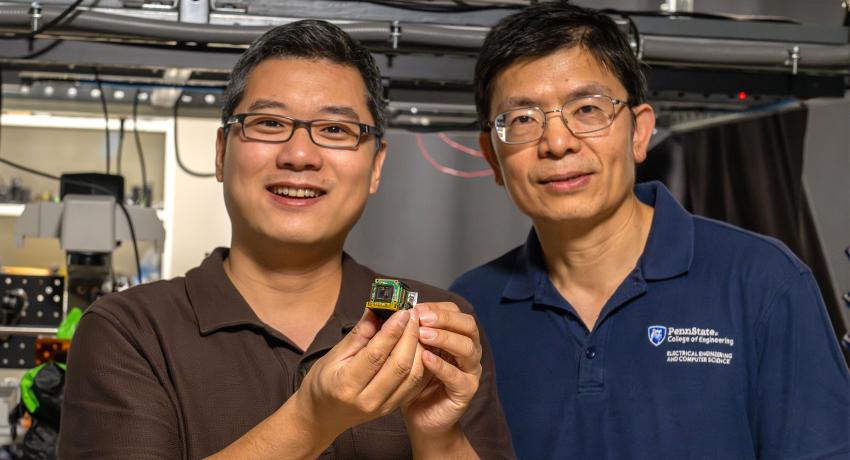 Two men holding a camera sensor