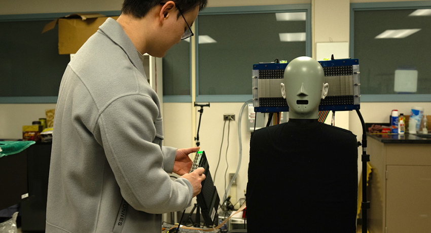 Photo of student in lab testing acoustics